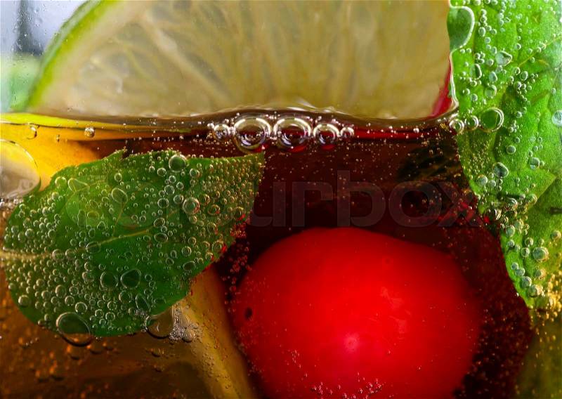 cola with lime , cherry and peppermint leaves , stock photo