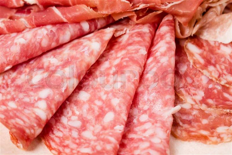 Closeup of prosciutto and salami italian platter. Macro. Photo can be used as a whole background, stock photo