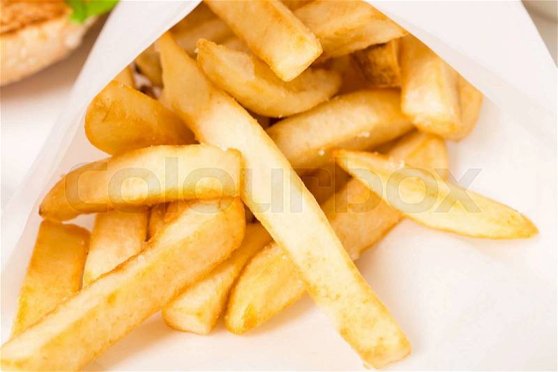 Closeup of french fries in a paper wrapper. Macro. Photo can be used as a whole background, stock photo