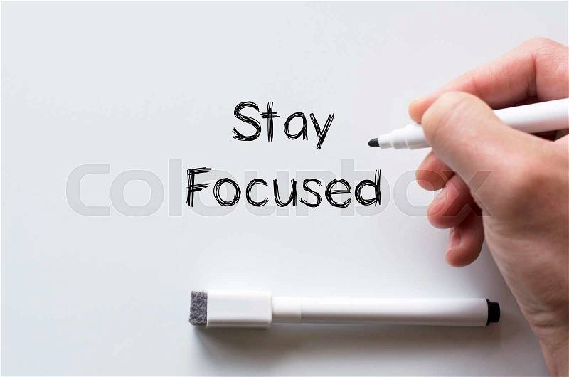 Human hand writing stay focused on whiteboard, stock photo