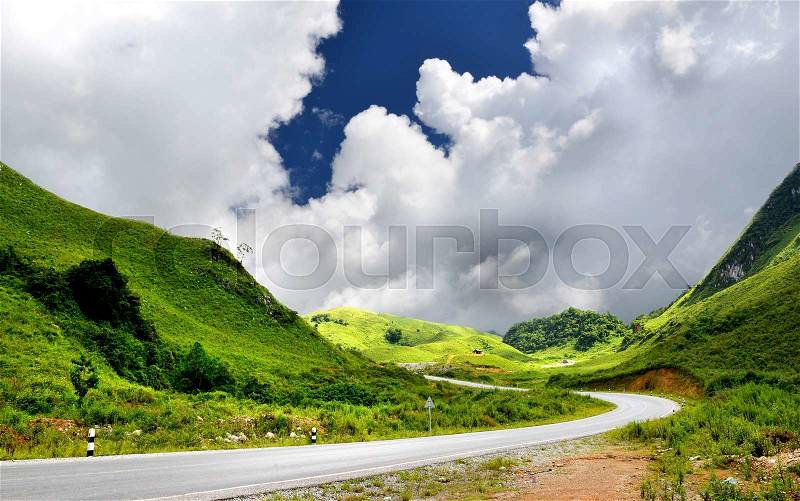 Mountain road in countryside of Lao in sunlight outdoor with blue sky and many cloud, stock photo