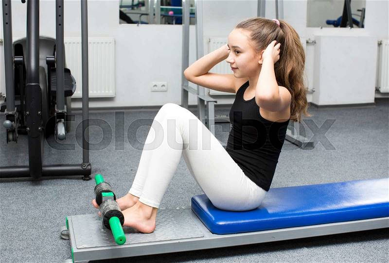 Girl is engaged in sports and gymnastics in the gym, stock photo