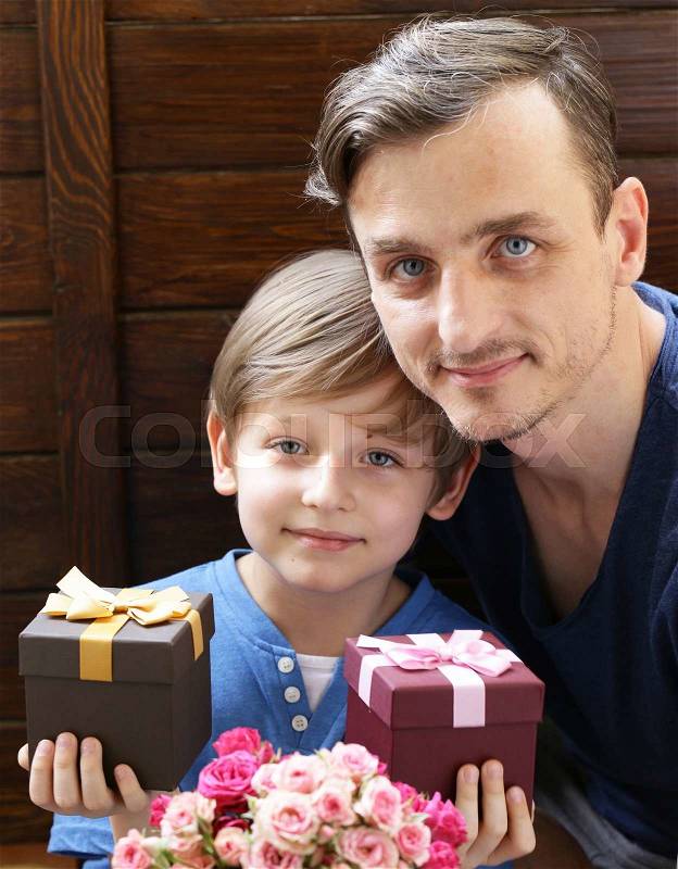 Husband and son presented to mom flowers and gifts, stock photo