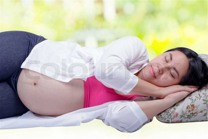 Happy beautiful asian pregnant woman sleeping peacefully, stock photo