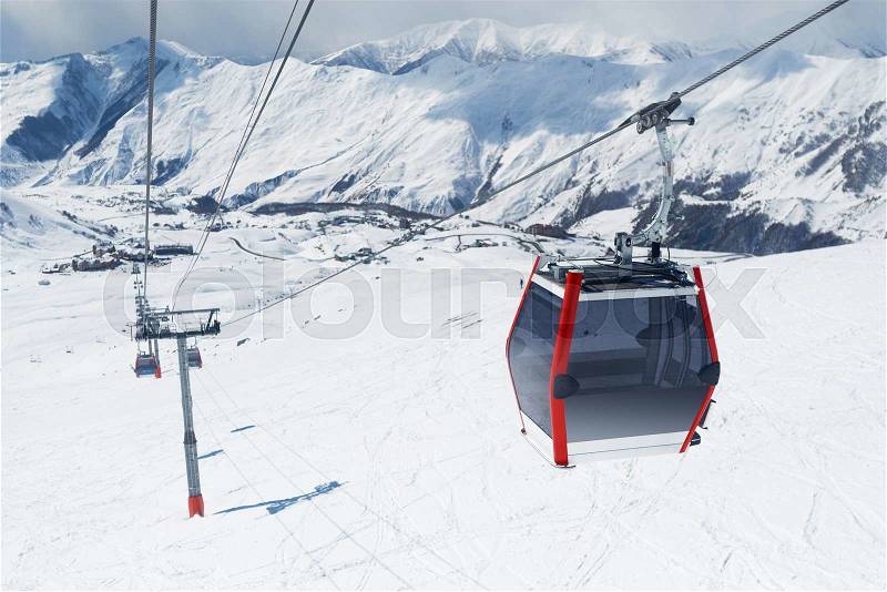 Gondola lift in the ski resort falls down the hill. Cableway in the mountains, stock photo