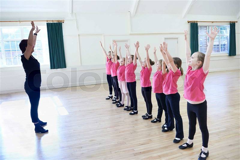 Group Of Girls In Tap Dancing Class With Teacher, stock photo