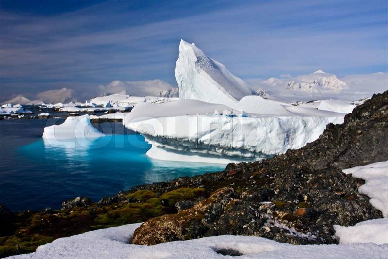 Huge iceberg in Antarctica, blue sky, azure water, sunny day, stock photo