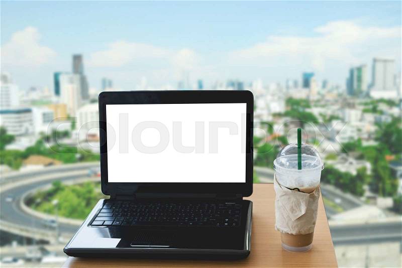 Blank screen of laptop, ice coffee cup, mock up, stock photo