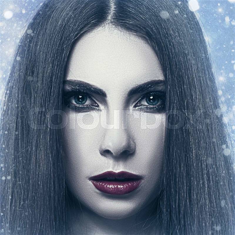 Snow Queen, grungy female portrait with snowfall as background, stock photo
