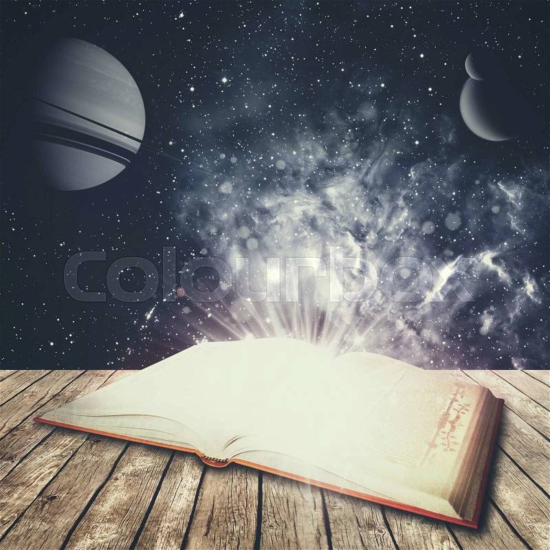 Abstract education and science backgrounds with opened book over desk. NASA imagery used , stock photo