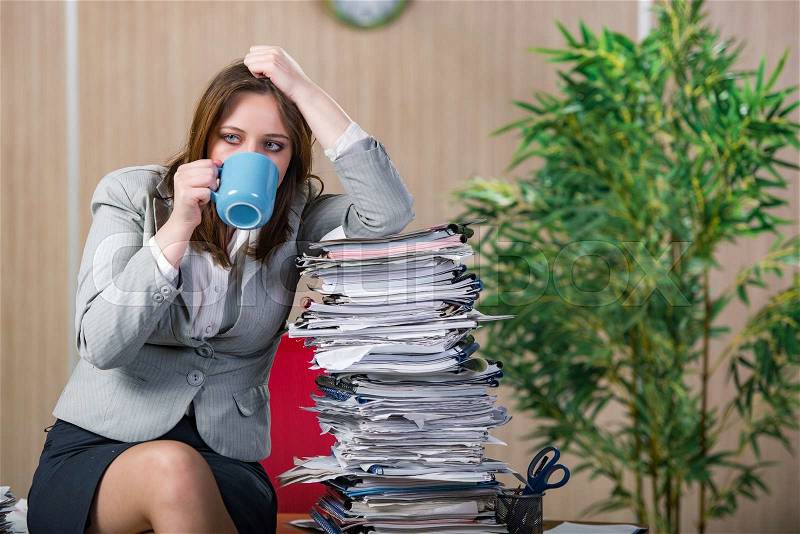 Businesswoman under stress working in the office, stock photo