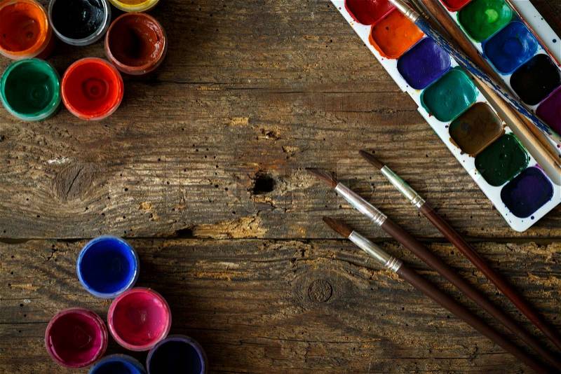 Art of Painting. Painting set: brushes, paints, watercolor, acrylic paint on a wooden background top down view, stock photo