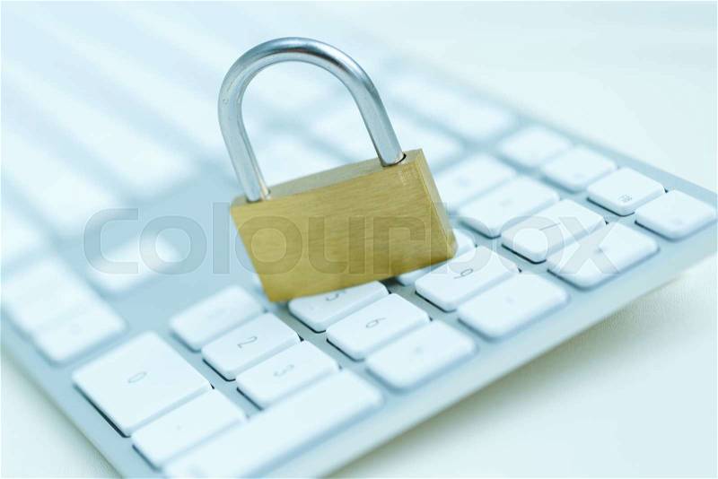 Security lock on white computer keyboard - computer security breach concept, stock photo