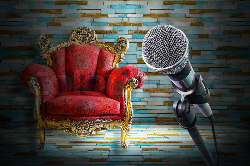 Microphone with red sofa on light stage, stock photo