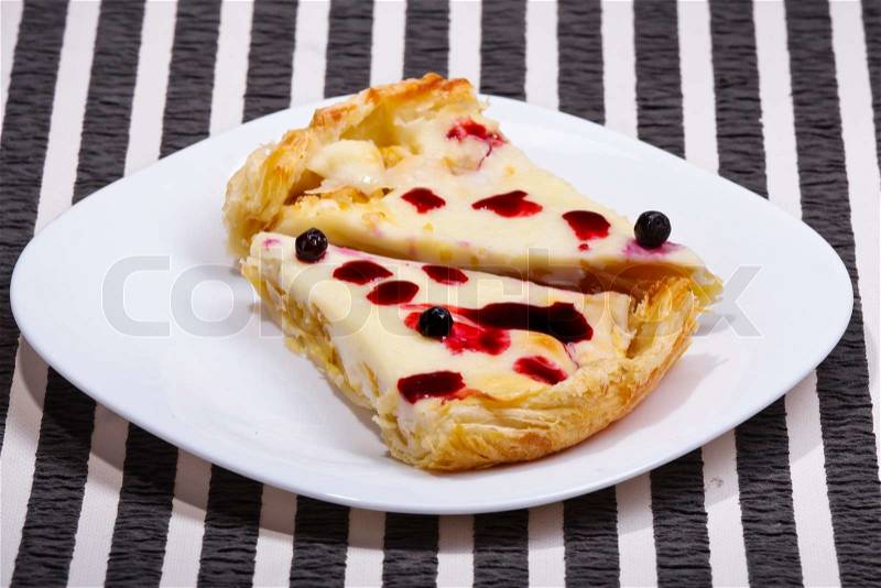 Apple-cream pie with blueberries on a striped background, stock photo