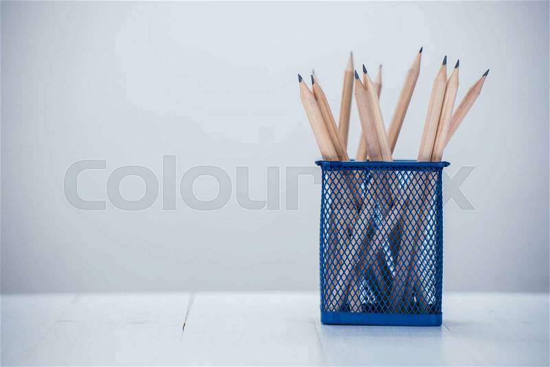 Pencil box on white wooden table, stock photo