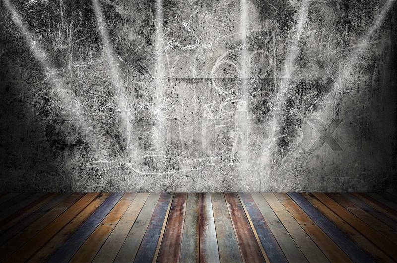 Light in dark room with colorful wooden floor and grunge stone wall, stock photo
