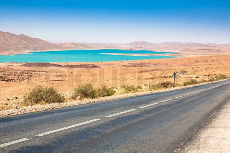Endless road in Sahara Desert with blue sky,Morocco Africa, stock photo