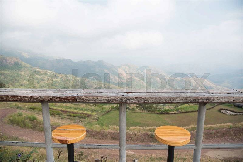 Outdoor bar counter and bar stools with beautiful natural mountain view background, stock photo