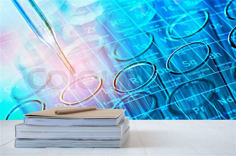 Book stack on white table with science laboratory test tubes background, stock photo