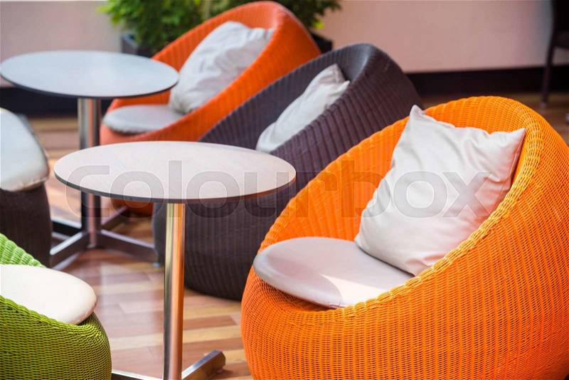 Colourful outdoor wicker chairs with cushions, stock photo