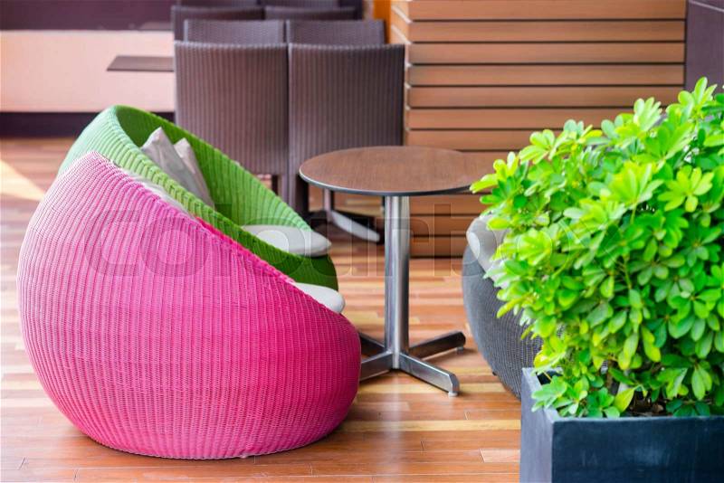 Colourful outdoor wicker chairs with cushions, stock photo