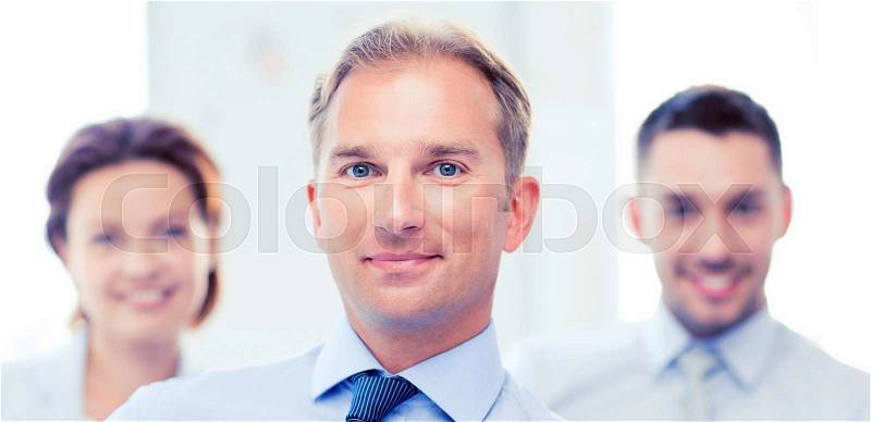Picture of smiling handsome businessman in office, stock photo