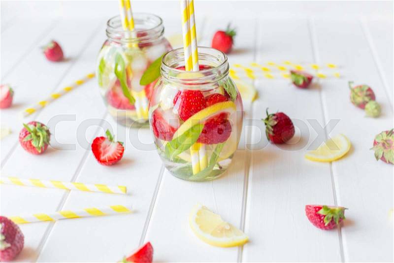 Strawberry lemonade with fresh mint on white wooden background, stock photo