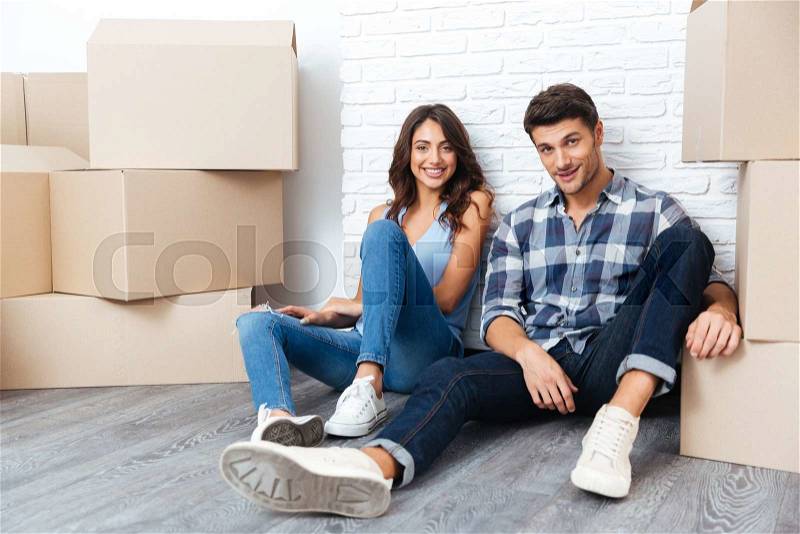 Young happy couple moving to new flat, stock photo