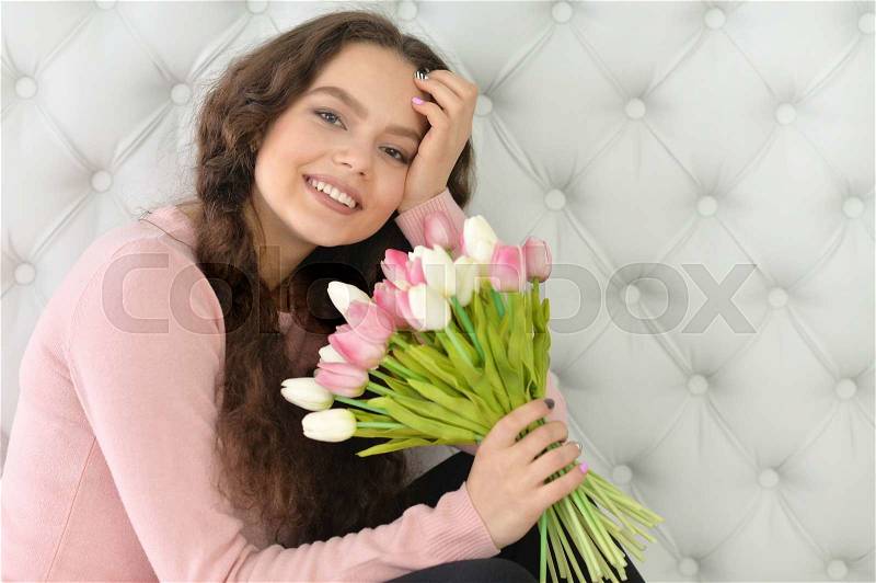 Portrait of a beautiful woman with tulips, stock photo