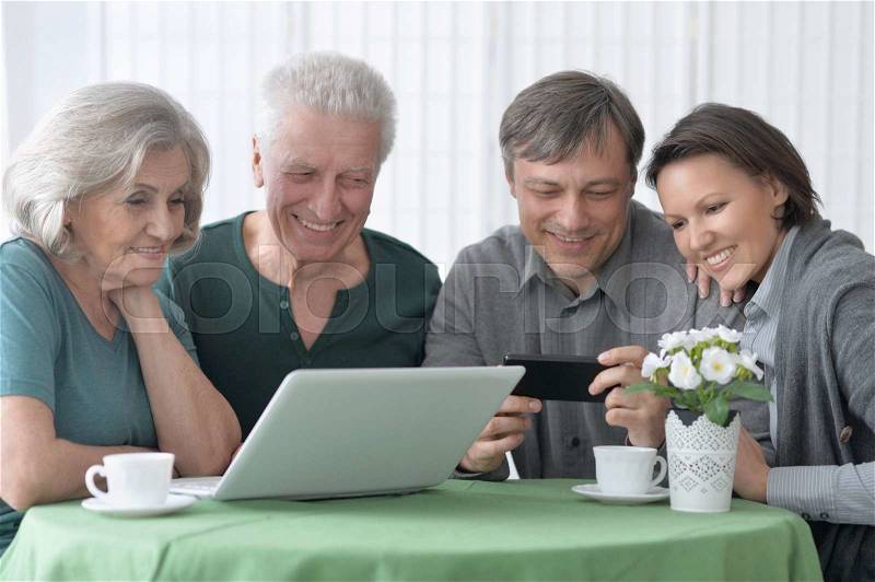Portrait of a happy smiling family portrait with laptop, stock photo