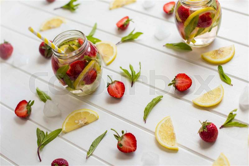 Cooking strawberry lemonade on a white wooden table, stock photo