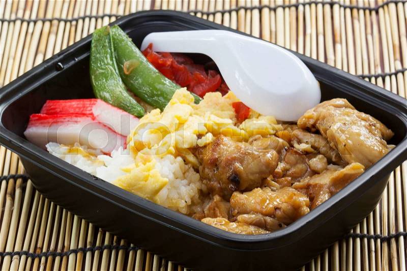 Chicken Toriyaki rice in plastic box with plastic spoon Japanese food , stock photo