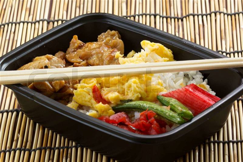 Chicken Toriyaki rice in plastic box with chopsticks Japanese food , stock photo