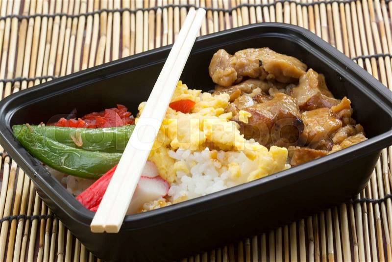 Chicken Toriyaki rice in plastic box with chopsticks Japanese food , stock photo