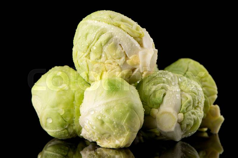 Fresh brussels sprouts isolated on black background, stock photo