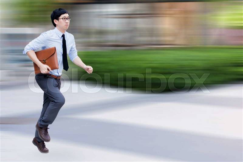 Asian businessman running with blurred motion of background, stock photo