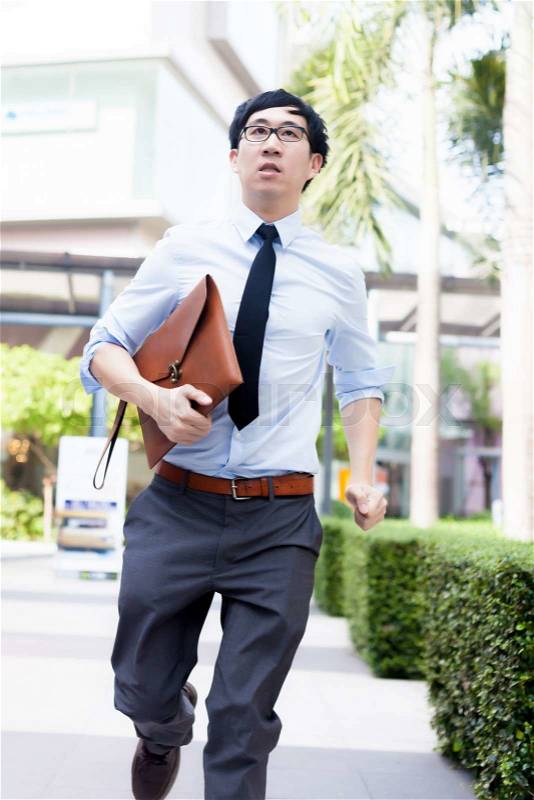 Young Business Asian exhausted man running late for work, stock photo