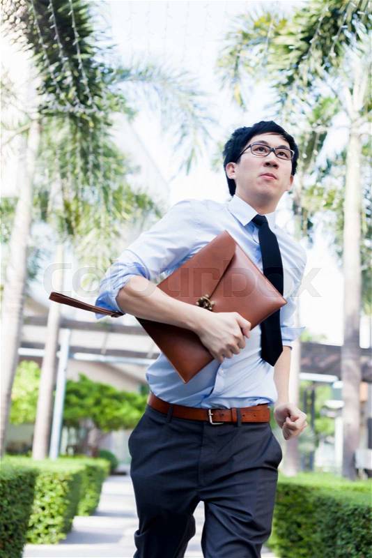 Young Business Asian exhausted man running late for work, stock photo