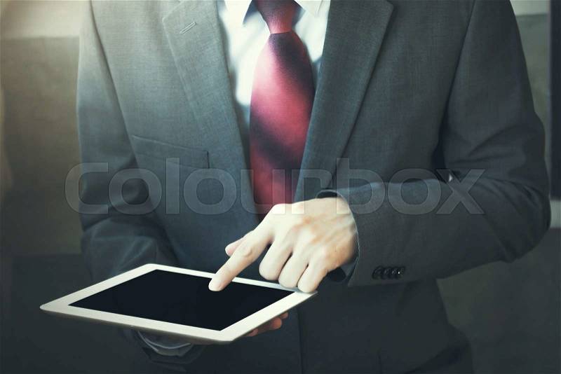 Close-up of Businessman using tablet - in vintage tone, stock photo