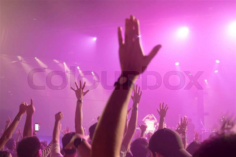 Music band crowds raising hands up in the air (Selective focus), stock photo