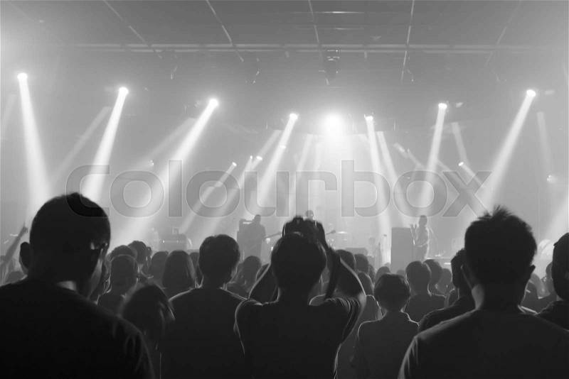 Music concert crowds illuminated from stage lights (very shallow depth of field) - Black and White, stock photo