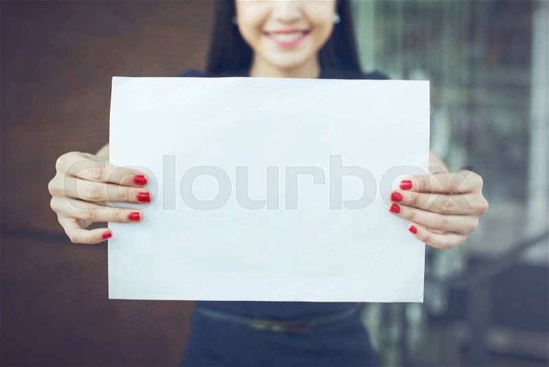 Half face of business woman holding an empty sign - ready to put text on, stock photo