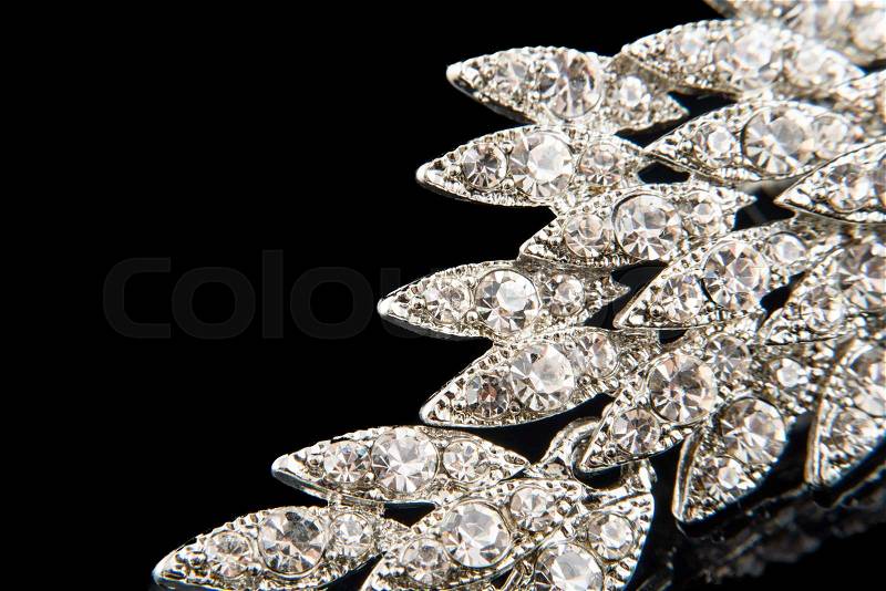 Details of vintage brooch with crystals isolated on black. Empty space for your text, stock photo