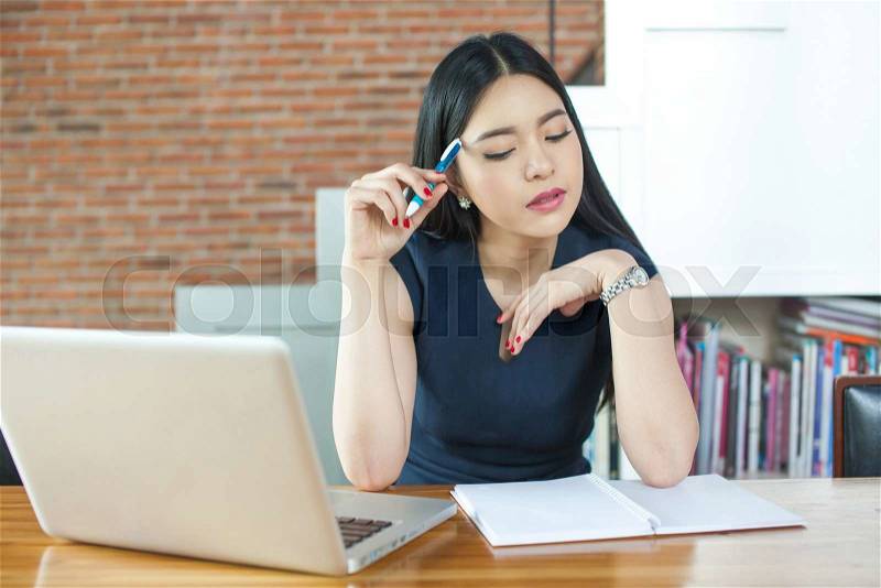 Asian Woman Thinking and Working in modern office, stock photo
