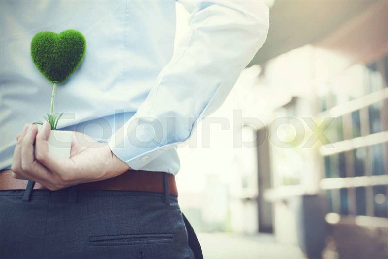 Man hands holding surprise gift from behind - love and relationship concept, stock photo