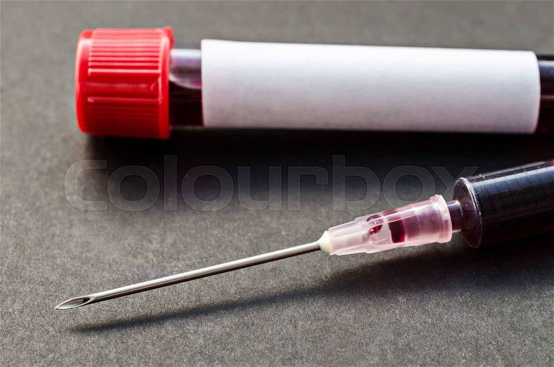 Needle syringe and sample blood with blood tube for test on black background, stock photo
