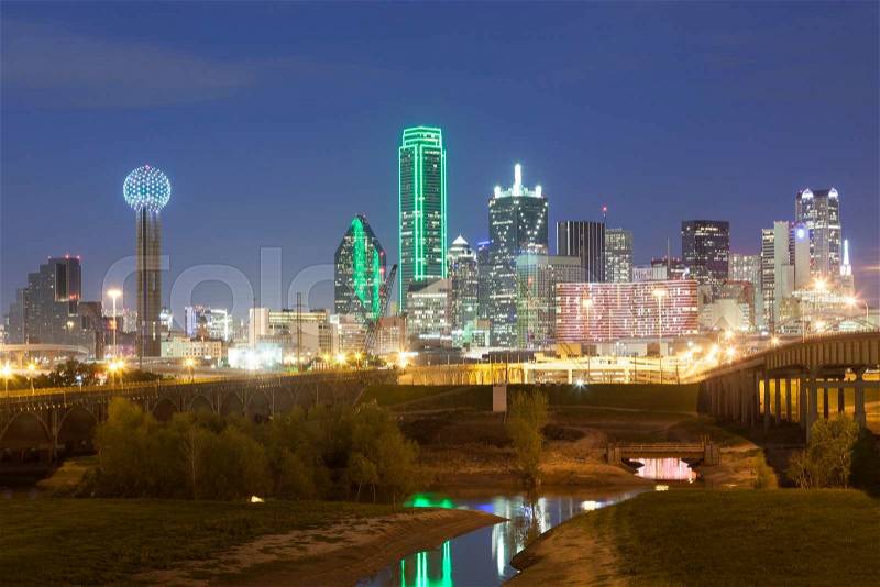Dallas downtown skyline illuminated at night with reflection in the Trinity River. Texas, United States, stock photo