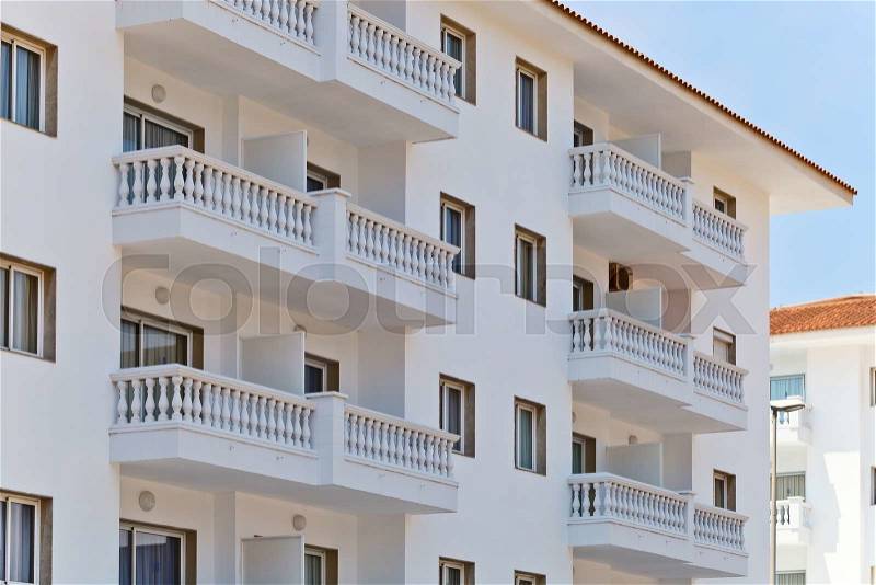 Detail of the facade of a apartment building, outdoor view of rows of balconies , stock photo