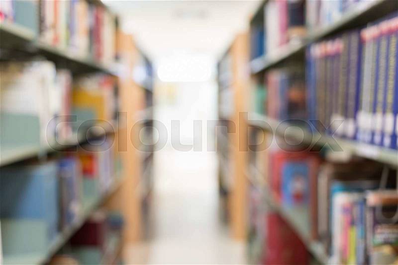 Books on bookshelf in library, abstract blur defocused background, stock photo
